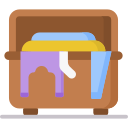 A wooden chest filled with folded clothes, with some garments, including a purple shirt and a blue item, hanging over the edge.